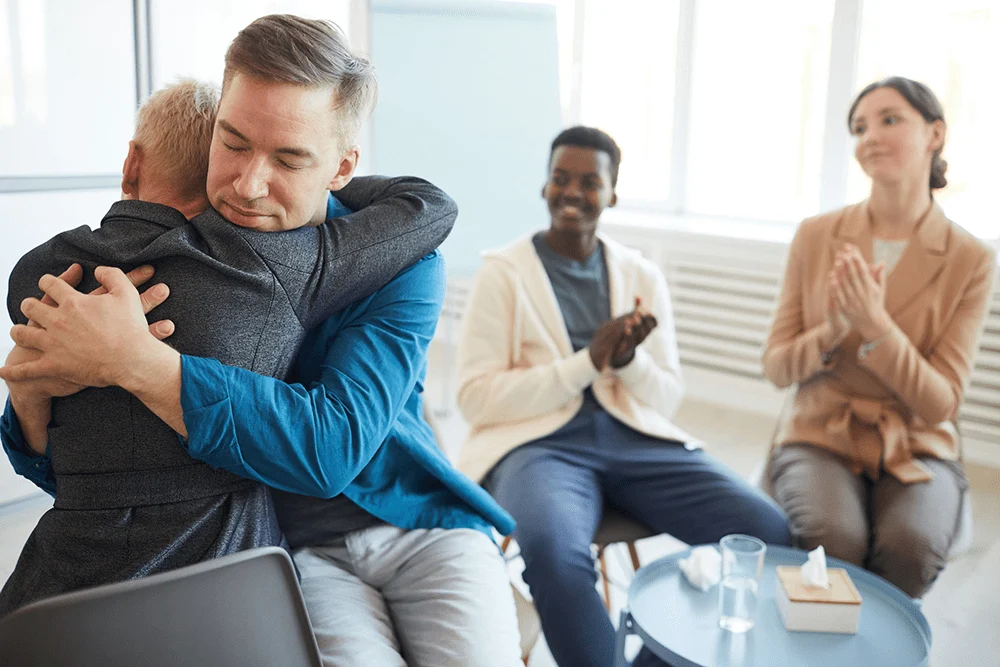Men supporting each other in group therapy for ketamine addiction