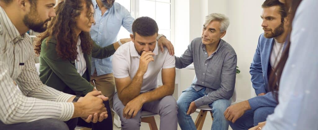 A man is comforted during Addiction treatment in Houston.