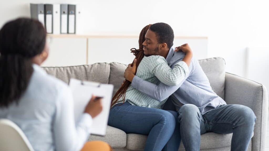 Couples hugging during therapy in Houston.