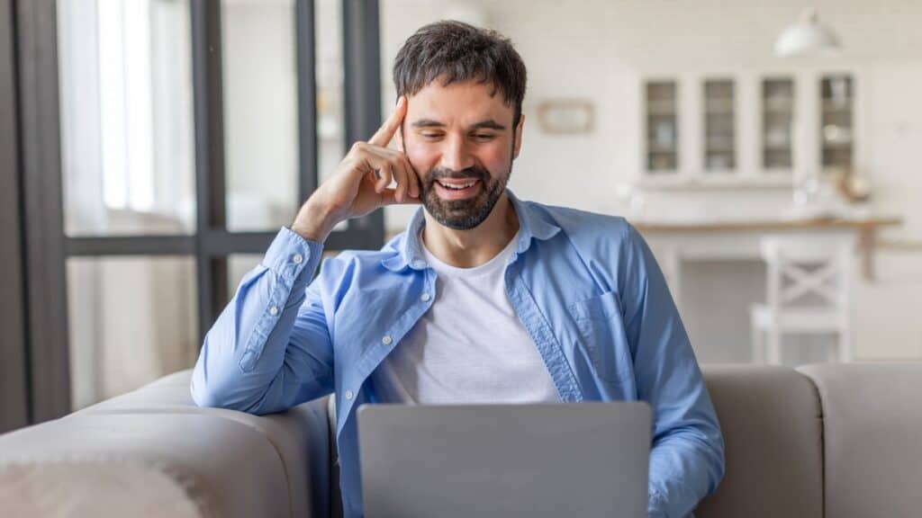 Man talks to therapist during virtual counseling in Houston, TX.