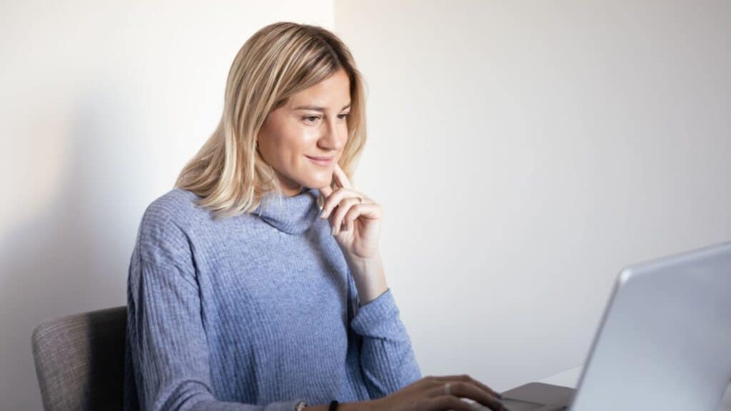 Woman stares at laptop during virtual counseling in Houston, TX.