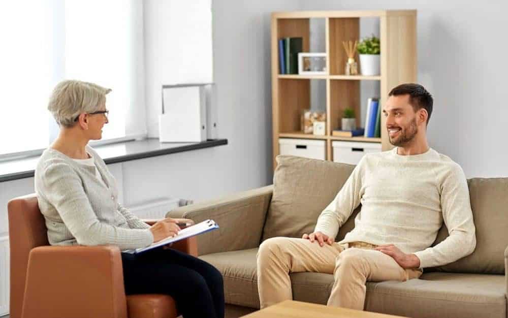 man smiling during therapy