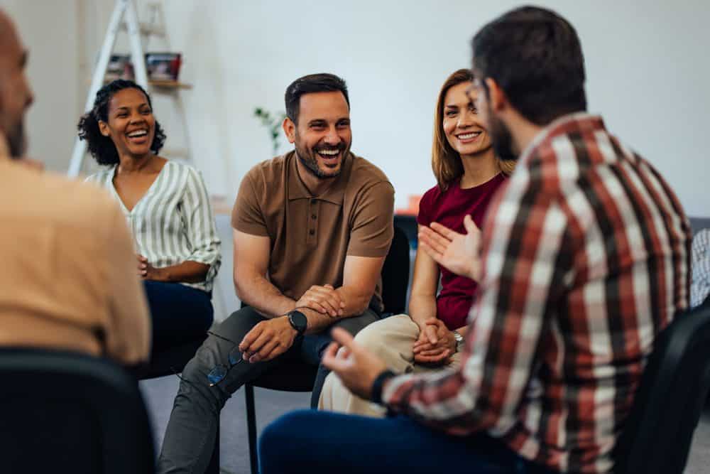 group-of-individuals-laughing-in-therapy