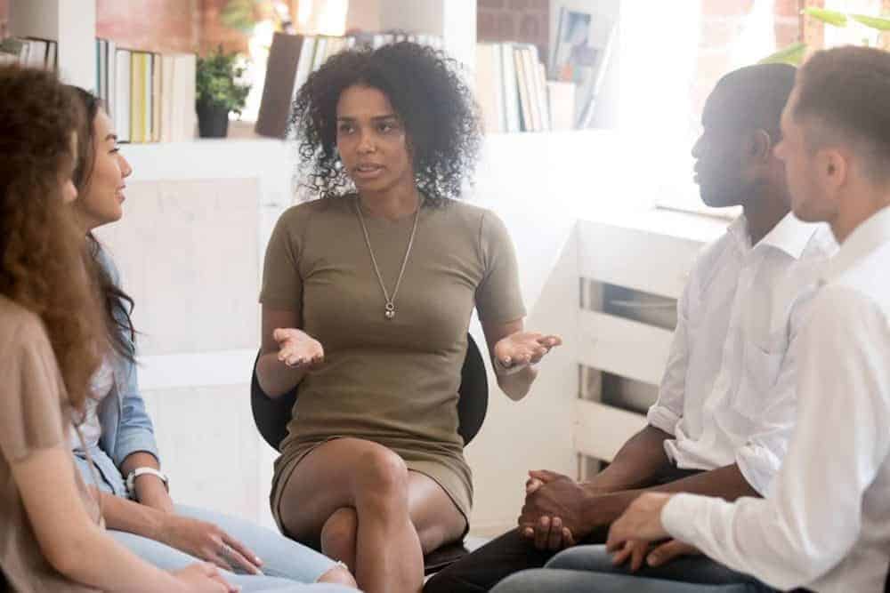 A Woman Speaking in Group Therapy