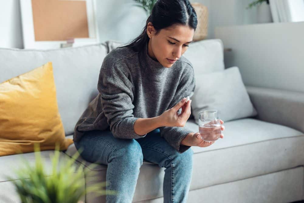 a-woman-holding-a-bottle-of-benzos