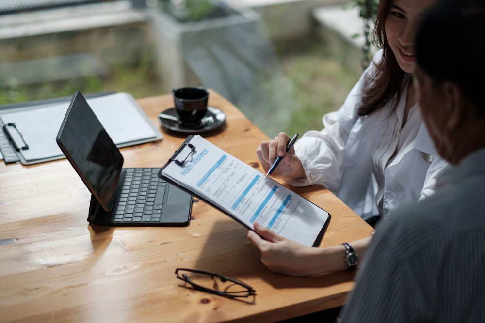 an individual filling out insurance paperwork